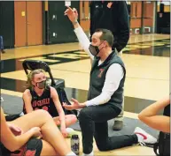  ?? Christian Abraham / Hearst Connecticu­t Media ?? Ridgefield girls basketball coach Rob Coloney huddles with his team on Feb. 10.