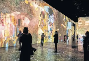  ?? PHOTOS COURTESY OF LIGHTHOUSE IMMERSIVE ?? Gustav Klimt’s most famous painting, “The Kiss,” is seen projected as part of the new show “Immersive Klimt: Revolution.” Klimt was part of a bohemian, avant-garde movement in Vienna.