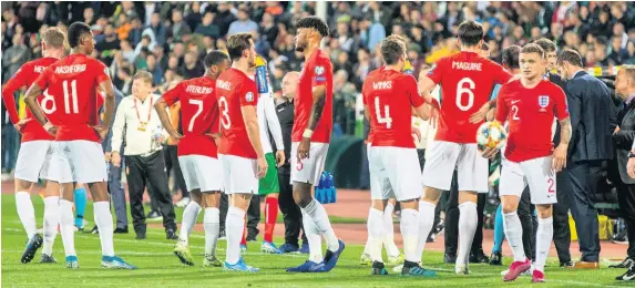  ??  ?? > The England-Bulgaria game is halted for the second time while players, officials and managers discuss the racist abuse aimed at the players