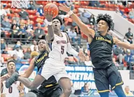  ?? CHARLES TRAINOR JR./MIAMI HERALD ?? Stranahan’s Brian Dugazon looks to score as Lakwood’s Jalen White (3) and Jamille Reynolds defend during the Boys Class 6A state basketball title game on Thursday.