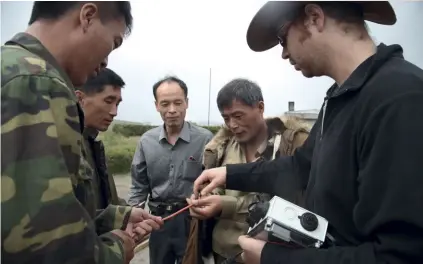  ??  ?? James Hammond and North Korean geologists are ready to install seismomete­rs on Mount Paektu.