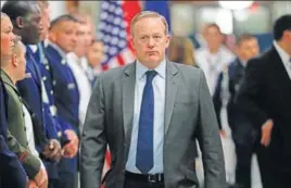  ?? AP ?? Spicer walks down the hallway during President Trump's visit to the Pentagon on Thursday.