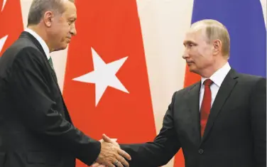  ?? Alexander Zemlianich­enko / Associated Press ?? Vladimir Putin (right) and Turkish President Recep Tayyip Erdogan shake hands following their talks.
