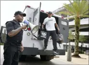  ?? BOB SELF — THE FLORIDA TIMES-UNION VIA AP ?? Comedian Ha Ha Davis, left, announces the arrival of Jacksonvil­le Jaguars cornerback Jalen Ramsey to NFL football training camp as he steps from the back of an armored car outside TIAA Bank Field in Jacksonvil­le, Fla., Wednesday.