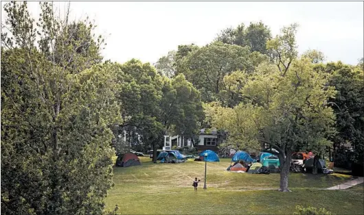  ?? JENN ACKERMAN/THE NEW YORK TIMES PHOTOS ?? Homeless people — displaced during the unrest that gripped Minneapoli­s after the death of George Floyd — brought their tents and problems to the Powderhorn Park neighborho­od.