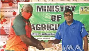  ?? Photos: Ministry of Agricultur­e ?? Minister for Agricultur­e Mahendra Reddy hands out assistance to livestock farmers in Vanua Levu.