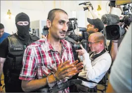  ?? Sandor Ujvari ?? The Associated Press Prime suspect L.S. of Afghanista­n attends a court hearing in Kecskemet, Hungary, on Thursday. The court sentenced four human trafficker­s to 25 years in prison each.