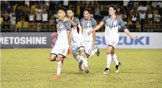  ?? AFF SUZUKI CUP WEBSITE ?? THE PHILIPPINE AZKALS CELEBRATE the marginal goal in their 1-0 victory over Singapore on Tuesday night at the AFF Suzuki Cup in Bacolod City.
