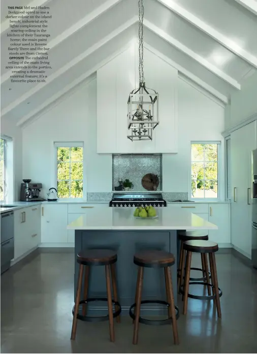  ??  ?? THIS PAGE Mel and Haden Bedggood opted to use a darker colour on the island bench; industrial style lights complement the soaring ceiling in the kitchen of their Tauranga home; the main paint colour used is Resene Barely There and the bar stools are from Cintesi.