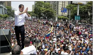  ?? AP/MARTIN MEJIA ?? Venezuela opposition leader Juan Guaido addresses thousands of supporters Wednesday in Caracas. “Let’s keep up the pressure in the streets,” he told them. “The end is around the corner!”