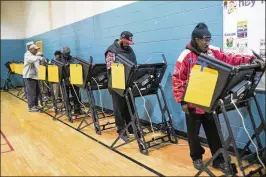  ?? MADDIE MCGARVEY / THE NEW YORK TIMES 2016 ?? Voters cast ballots in Columbus in November 2016. The Supreme Court ruled Monday a state may kick people off the rolls if they skip a few elections and fail to respond to a notice from state election officials.