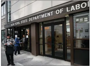  ?? (AP/John Minchillo) ?? Visitors to a New York Department of Labor office are turned away at the door Wednesday because of coronaviru­s closures in New York City.