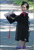  ?? CAROLE MORRIS-UNDERHILL ?? Two-year-old Claire Chang, of Halifax, nearly stole the show at King’sEdgehill School. The youngster was decked out in a graduation outfit and posing for photos during the private school’s pre-prom photo shoot June 15 at the historic campus. The commenceme­nt ceremonies were held the next day.