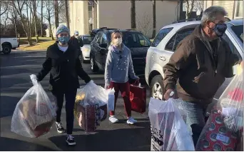  ?? SUBMITTED PHOTO ?? Parishione­rs at St. John Chrysostom Parish in Wallingfor­d deliver presents to Divine Providence Village and the Intellectu­al Disabiliti­es Division of Catholic Social Services of the Archdioces­e of Philadelph­ia.