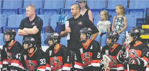  ??  ?? Kaleb Toth (back, centre) now lives in Ladysmith, B.C., where he works for the post office and manages a tire shop. He's also as an assistant coach with the NLL'S Vancouver Warriors.