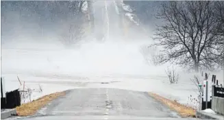  ?? MATHEW MCCARTHY WATERLOO REGION RECORD ?? Wilby Road was closed after the Nith River spilled over it, east of Nafziger Road, on Tuesday.