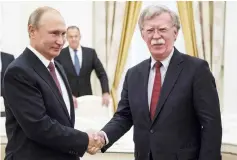  ??  ?? Putin (left) shakes hands with Bolton during their meeting in the Kremlin in Moscow. — AFP photo