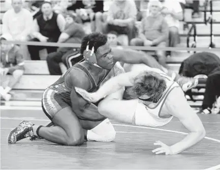  ?? PAUL W. GILLESPIE/BALTIMORE SUN MEDIA GROUP ?? Old MIll's Jason Smith, left, wrestles his way to a victory over Leonardtow­n’s Steven Bieshelt in the 182-pound championsh­ip match at the Class 4A-3A East Region wrestling tournament at Severna Park on Saturday night. Both wrestlers advanced to the...