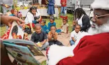  ?? Annie Mulligan/Contributo­r ?? Children listen during Storytime with Santa on Saturday at Kindred Stories, a Black-owned bookstore in Third Ward.