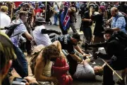  ?? MATT EICH / NEW YORK TIMES ?? “Unite the Right,”supporters and counterpro­testers in 2017 in Charlottes­ville, Va. The lawsuit against organizers of the march will examine one of the most violent manifestat­ions of far-right views in recent history.