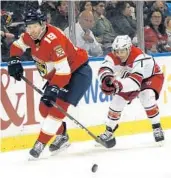  ?? JOE SKIPPER/AP ?? Defenseman Mike Matheson, left, keeps the puck away from Hurricanes center Derek Ryan in the first period.