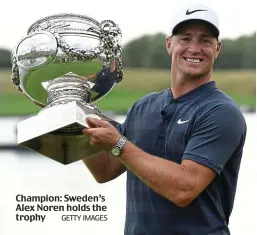  ?? GETTY IMAGES ?? Champion: Sweden’s Alex Noren holds the trophy