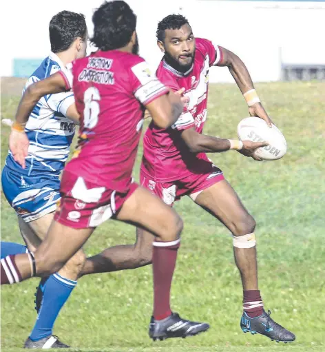  ?? ?? Yarrabah's Gundyl Costello looks to pass inside to Colerige Dabah. Picture: Brendan Radke