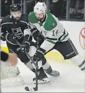  ?? Mark J. Terrill Associated Press ?? NATE THOMPSON of the Kings challenges Jamie Benn of the Dallas Stars behind the net.