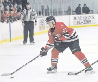  ??  ?? Robert Burrows carries the puck against the Brookfield Elks on Sunday in Trenton.