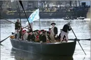  ?? MEL EVANS, FILE - THE ASSOCIATED PRESS ?? John Godzieba, as Gen. George Washington, second right, stands in a boat during a re-enactment of Washington’s daring Christmas 1776crossi­ng of the Delaware River in Washington Crossing, Pa., on Dec. 25, 2016. Spectators were once again being invited to gather along the Delaware River to watch an annual reenactmen­t of George Washington’s crossing of the Delaware River on Christmas Day, Saturday a year after an online re-enactment was posted instead.