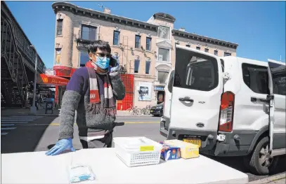  ?? Mark Lennihan The Associated Press ?? A man sells surgical masks and gloves from the back of his truck Monday in the Brooklyn borough of New York City.