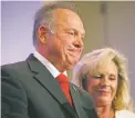  ?? THE ASSOCIATED PRESS ?? A sex scandal has relegated U.S. Senate candidate Roy Moore’s hard-line positions on LGBT issues to the background in Alabama’s race. At right is his wife, Kayla.