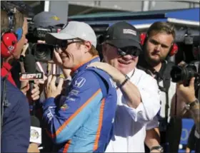  ?? MICHAEL CONROY — THE ASSOCIATED PRESS ?? Car owner Chip Ganassi congratula­tes driver Scott Dixon, of New Zealand, after he won the pole during qualificat­ions for the Indianapol­is 500 IndyCar auto race at Indianapol­is Motor Speedway, Sunday in Indianapol­is.