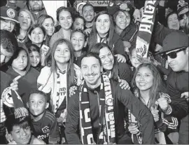  ?? MARK RALSTON AFP/Getty Images ?? ZLATAN IBRAHIMOVI­C is greeted by fans after arriving at Los Angeles Internatio­nal Airport to begin a two-year contract with the Galaxy.