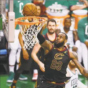  ?? Adam Glanzman / Getty Images ?? LeBron James drives to the basket in the second half against the Boston Celtics during Game Five of the Eastern Conference Finals on Wednesday.