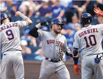  ?? ORLIN WAGNER ?? Houston’s Max Stassi (12) celebrates his three-run homer with teammates Marwin Gonzalez (9) and Yuli Gurriel during the Astros’ 7-4 victory, their 11th straight.