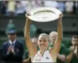  ?? TIM IRELAND — THE ASSOCIATED PRESS ?? Germany’s Angelique Kerber lifts the trophy after winning the women’s singles final match against Serena Williams of the United States, at the Wimbledon Tennis Championsh­ips, in London, Saturday.