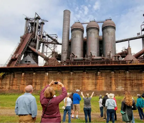  ??  ?? People take a pre-pandemic tour of the Carrie Blast Furnaces in Swissvale which is part of the Rivers of Steel Museum.