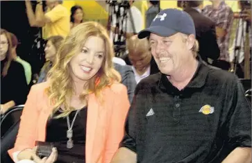  ?? Anne Cusack Los Angeles Times ?? JEANIE and brother Jim chat before a news conference introducin­g new Laker Dwight Howard in 2012. At the time, Jim was the team’s executive vice president of basketball operations. She fired him four months ago.