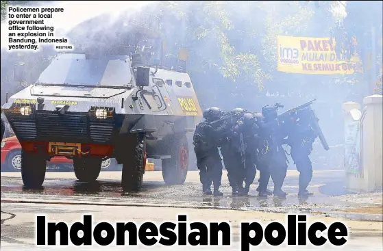  ?? REUTERS ?? Policemen prepare to enter a local government office following an explosion in Bandung, Indonesia yesterday.