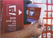  ?? Damian Dovarganes / Associated Press 2009 ?? Redbox in 2013 started a Netflix-like subscripti­on service through a deal with Verizon, which was not successful.