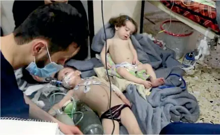  ?? PHOTO: AP ?? This image made from video released by the Syrian Civil Defence White Helmets, which has been authentica­ted based on its contents and other AP reporting, shows medical workers treating toddlers following an alleged poison gas attack in the...