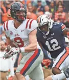  ?? THOMAS GRANING, AP ?? Mississipp­i tight end Dawson Knox (9) runs past Auburn defensive back Jamel Dean in Auburn, Ala., in last year’s game.