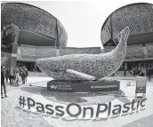  ??  ?? People look at "Plasticus", a 10-metre installati­on, to raise awareness about the problem of ocean plastic pollution, depicting a whale and made up of 250 kg of plastic waste, in central Rome. The 250 kg of plastic used to create "Plasticus" is the...