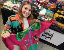  ?? Dan Watson/ The Signal ?? Madison Cruz, 14, with some of the hundreds of vintage, Peruvian pima cotton, Sweater Weather sweaters in her garage.