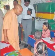  ?? HT PHOTO ?? Chief minister Yogi Adityanath interactin­g with schoolchil­dren during a surprise inspection at a primary school in Gorakhnath area on Thursday.