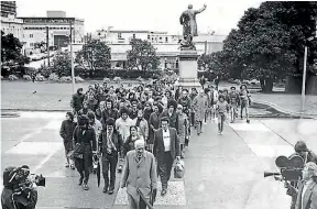  ?? SIMON O’CONNOR/STUFF and AUCKLAND STAR ?? Nathan Mansell and his son Tumanako Mansell read a children’s book in te reo Māori, left. The Māori language petition was delivered to Parliament in 1972, above.