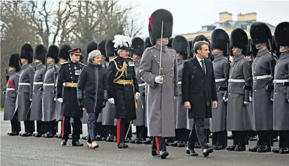  ??  ?? Theresa May and Emmanuel Macron inspect a guard of honour at the Royal Military Academy Sandhurst in Berkshire yesterday. Mr Macron warned that single market access was not possible without freedom of movement