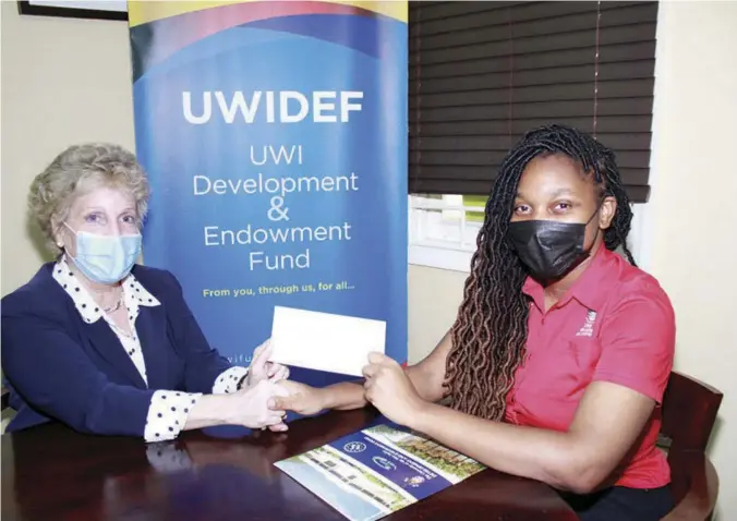  ?? ?? From left to right: Mrs. Carla Seaga, Executive Director hands cheque to Miss Danielle Mullings, President, Guild of Students, UWI Mona.