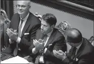  ?? AP/GREGORIO BORGIA Prime Minister Giuseppe Conte (center) applauds Tuesday after winning a second confidence vote at the Senate in Rome. ??